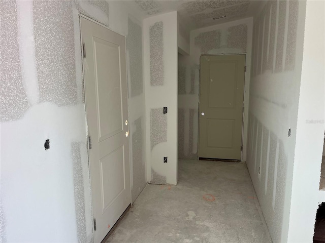 hall featuring concrete flooring