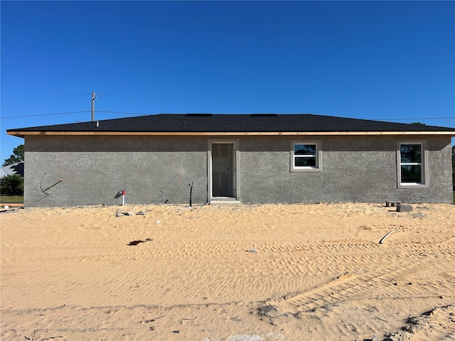 back of house featuring stucco siding