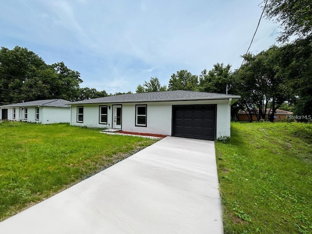 ranch-style house featuring driveway, an attached garage, a front yard, and stucco siding