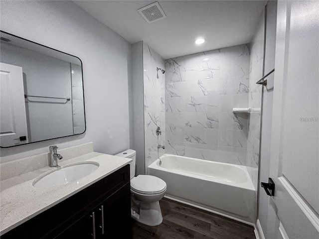 full bath featuring vanity, toilet, tub / shower combination, visible vents, and wood finished floors