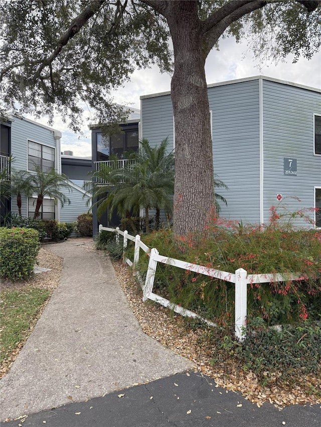 view of side of property featuring fence