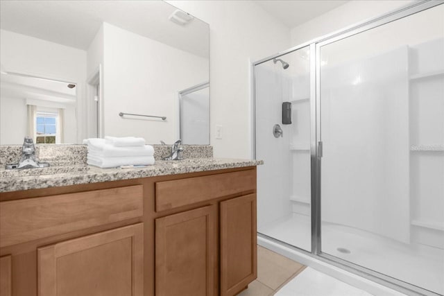 full bathroom featuring a stall shower, tile patterned floors, and vanity