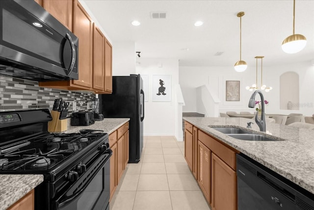 kitchen with backsplash, a sink, light tile patterned floors, visible vents, and black appliances