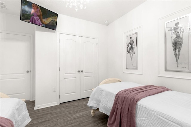 bedroom featuring a closet, visible vents, and wood finished floors