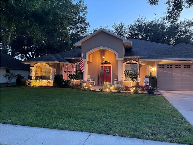 4907 Raylene Way, Saint Cloud, FL 34771 - view of front facade with an attached garage, stucco siding, concrete driveway, a shingled roof, and a front yard