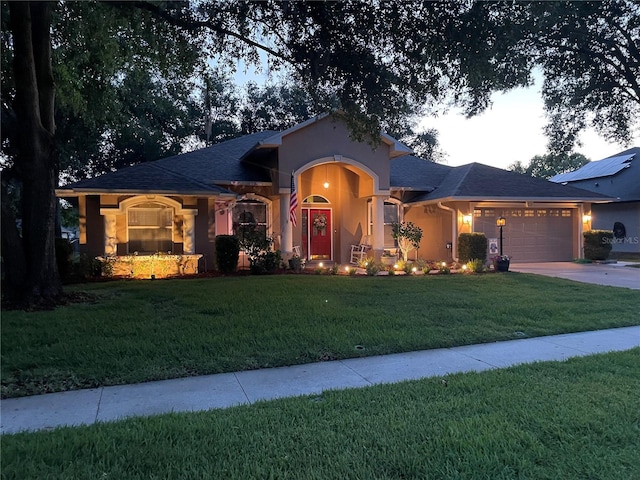 4907 Raylene Way, Saint Cloud, FL 34771 - ranch-style home featuring a garage, stucco siding, a front lawn, and driveway