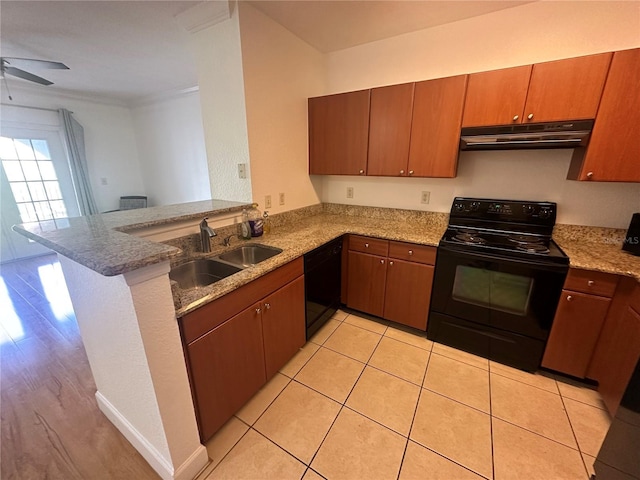 304 E S St Unit 5020, Orlando, FL 32801 - kitchen with range hood, a sink, light stone counters, a peninsula, and black appliances