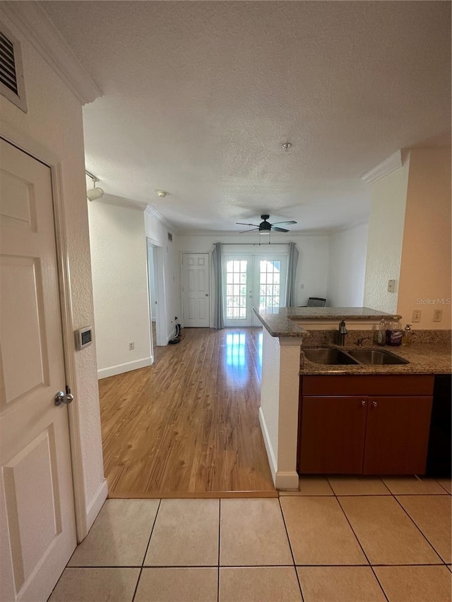 304 E S St Unit 5020, Orlando, FL 32801 - kitchen featuring light tile patterned floors, ornamental molding, a textured ceiling, a sink, and ceiling fan