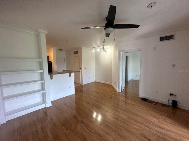 304 E S St Unit 5020, Orlando, FL 32801 - unfurnished living room with ornamental molding, visible vents, and wood finished floors