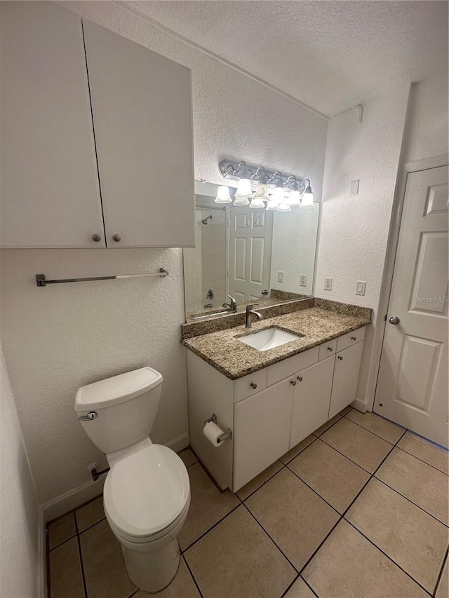 304 E S St Unit 5020, Orlando, FL 32801 - full bath with a shower, tile patterned flooring, vanity, toilet, and a textured wall