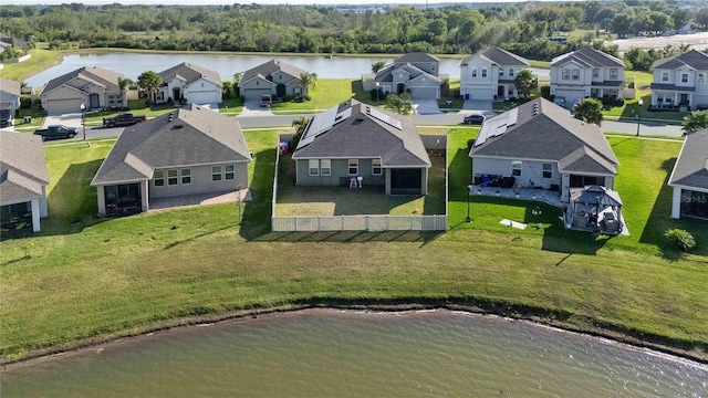 drone / aerial view with a residential view and a water view