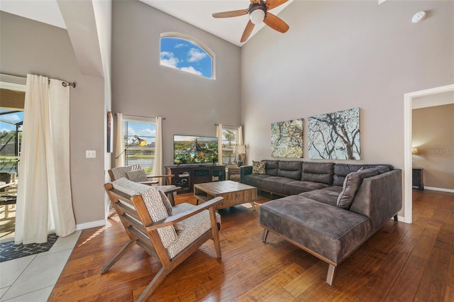 1048 Lake Berkley Dr, Kissimmee, FL 34746 - living area featuring a towering ceiling, a ceiling fan, and a wealth of natural light