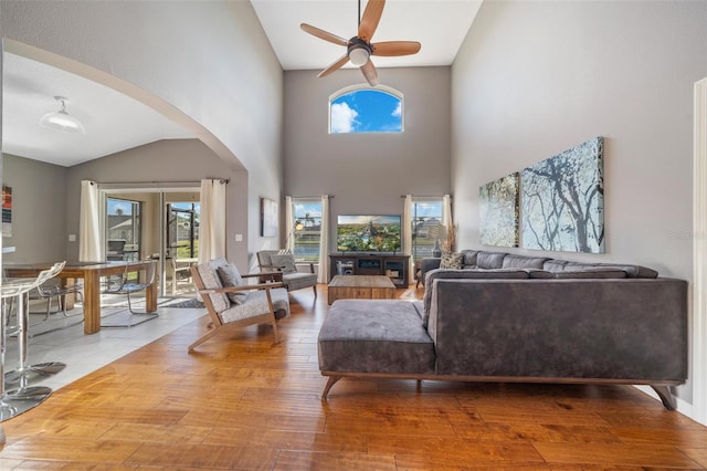 1048 Lake Berkley Dr, Kissimmee, FL 34746 - living room with wood-type flooring, ceiling fan, arched walkways, and plenty of natural light