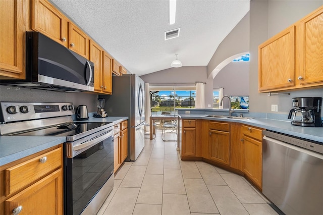 1048 Lake Berkley Dr, Kissimmee, FL 34746 - kitchen with arched walkways, visible vents, vaulted ceiling, a sink, and stainless steel appliances