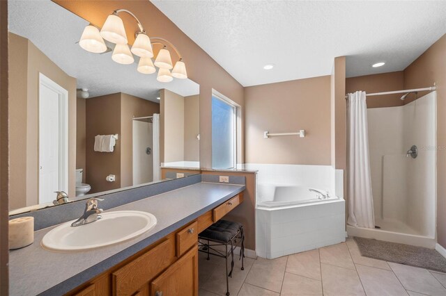 1048 Lake Berkley Dr, Kissimmee, FL 34746 - full bathroom featuring a garden tub, a shower stall, vanity, tile patterned flooring, and toilet