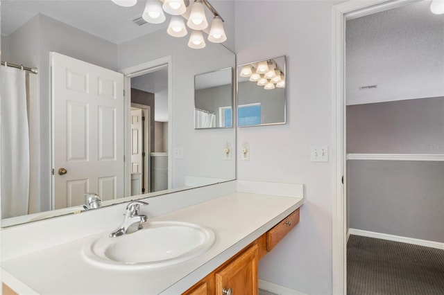 1048 Lake Berkley Dr, Kissimmee, FL 34746 - bathroom featuring visible vents, baseboards, an inviting chandelier, and vanity
