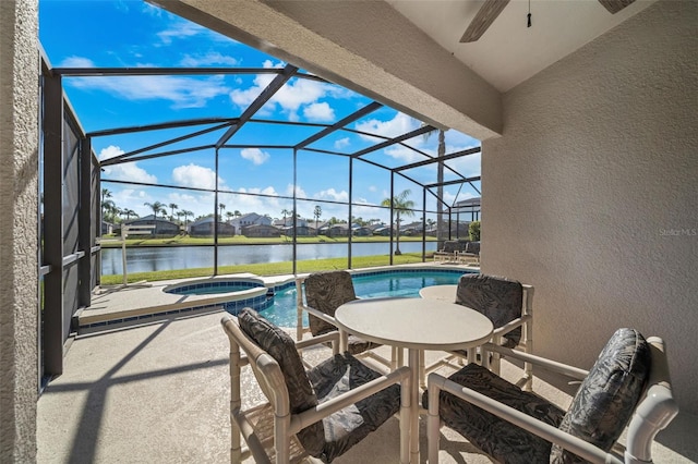 1048 Lake Berkley Dr, Kissimmee, FL 34746 - view of patio / terrace featuring a water view, glass enclosure, a pool with connected hot tub, and a ceiling fan