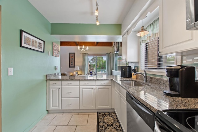 kitchen featuring white cabinetry, a sink, tasteful backsplash, and appliances with stainless steel finishes