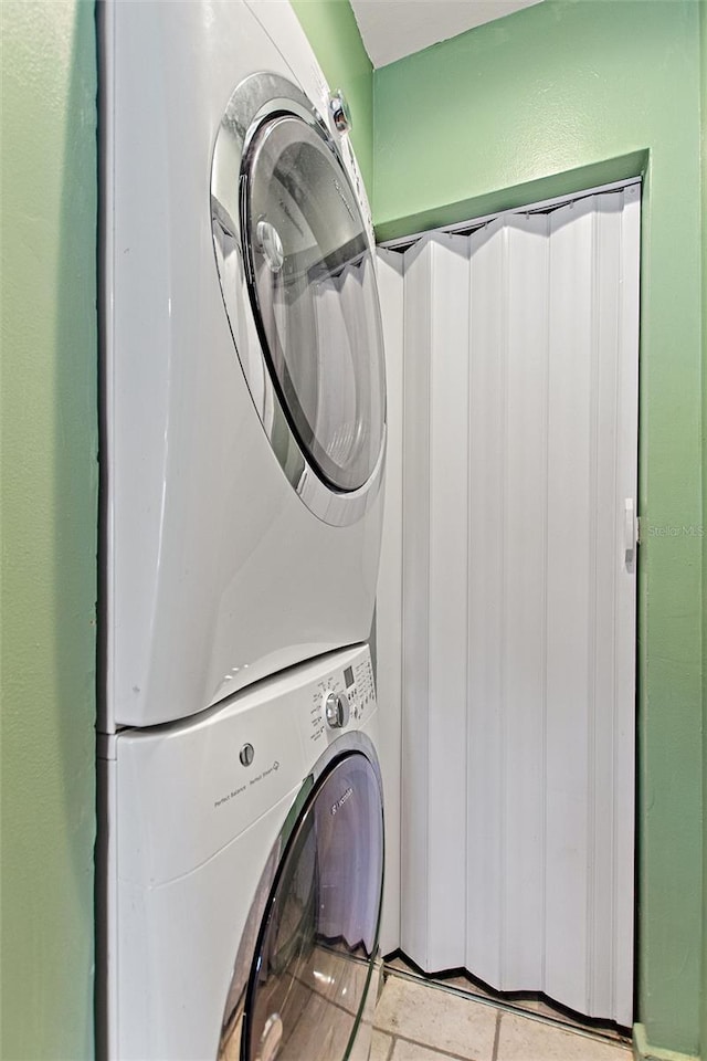 clothes washing area with stacked washer / dryer and laundry area