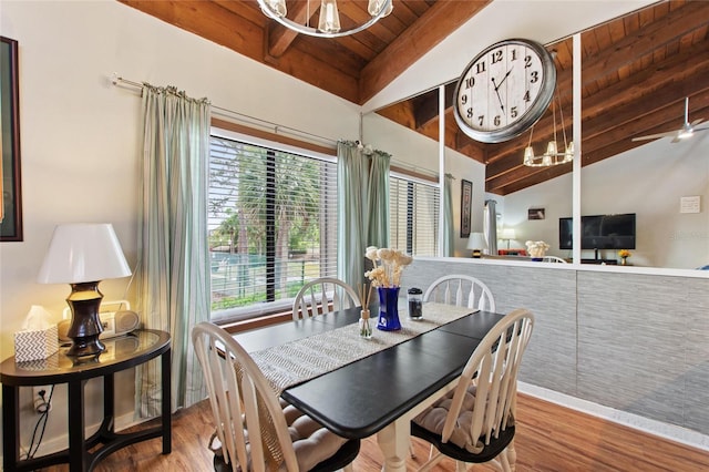 dining area with an inviting chandelier, wooden ceiling, vaulted ceiling with beams, and wood finished floors