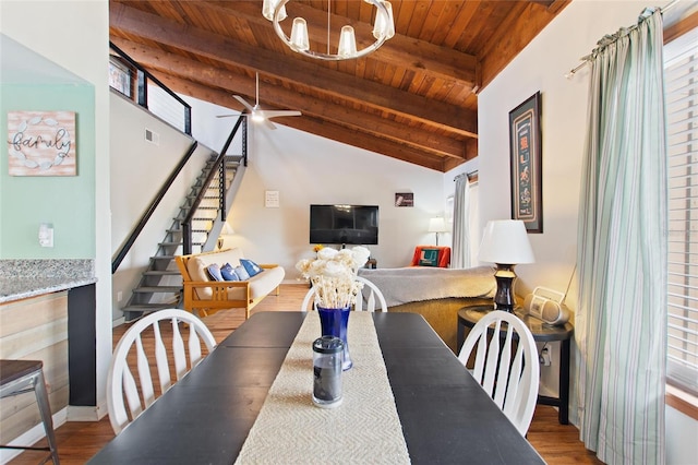 dining area featuring wooden ceiling, stairway, vaulted ceiling with beams, wood finished floors, and ceiling fan