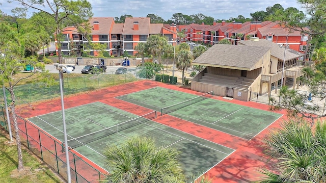 view of sport court featuring a residential view and fence