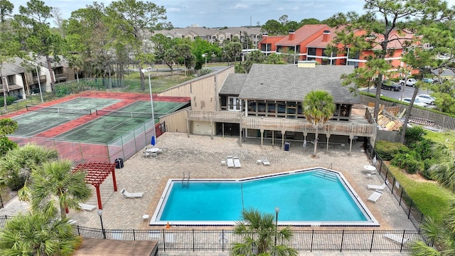 pool with a residential view, fence, and a patio area