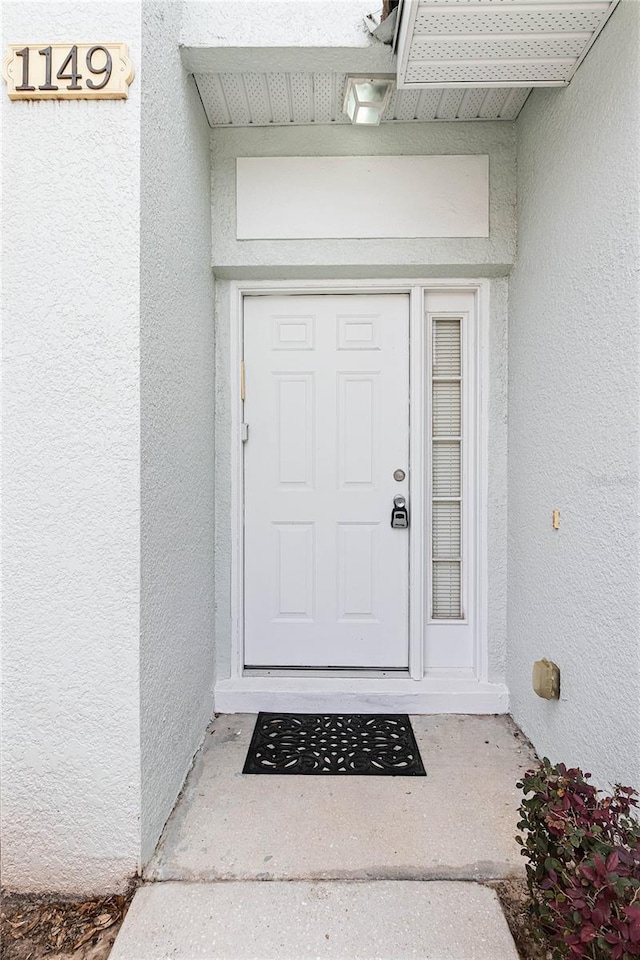 1149 S Beach Cir, Kissimmee, FL 34746 - doorway to property featuring stucco siding