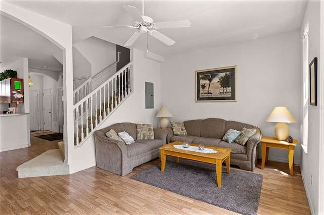 1149 S Beach Cir, Kissimmee, FL 34746 - living room featuring a ceiling fan, wood finished floors, electric panel, and stairs