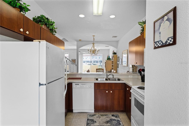1149 S Beach Cir, Kissimmee, FL 34746 - kitchen with a chandelier, white appliances, light countertops, light tile patterned flooring, and a sink