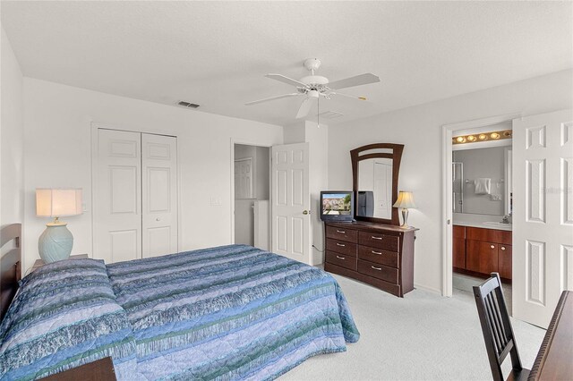 1149 S Beach Cir, Kissimmee, FL 34746 - bedroom featuring ceiling fan, connected bathroom, a closet, visible vents, and light carpet