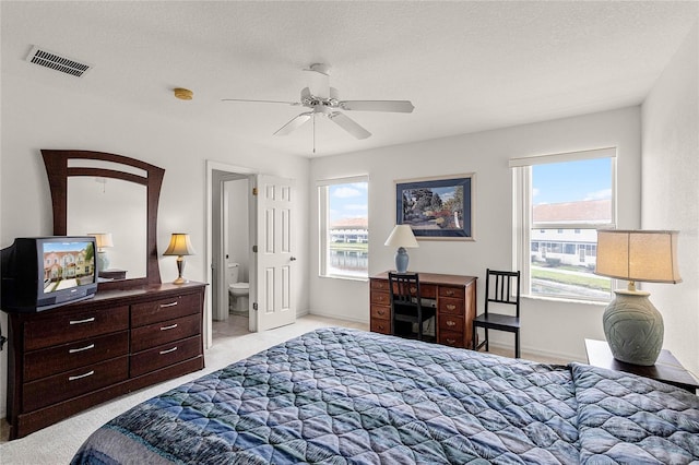 1149 S Beach Cir, Kissimmee, FL 34746 - bedroom featuring light carpet, ceiling fan, visible vents, and a textured ceiling