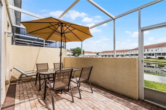 1149 S Beach Cir, Kissimmee, FL 34746 - view of patio featuring outdoor dining space and glass enclosure
