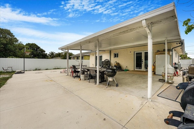 view of patio / terrace with french doors and fence