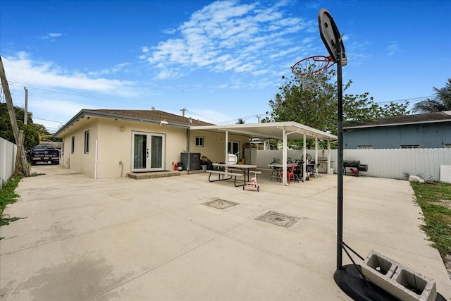 back of property featuring a patio area, french doors, a fenced backyard, and stucco siding
