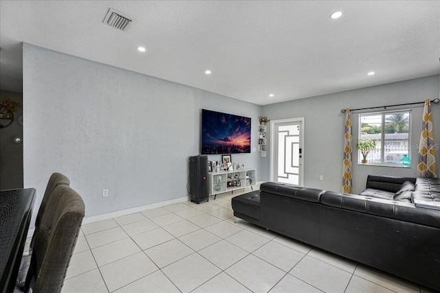 living room with visible vents, baseboards, recessed lighting, and light tile patterned floors