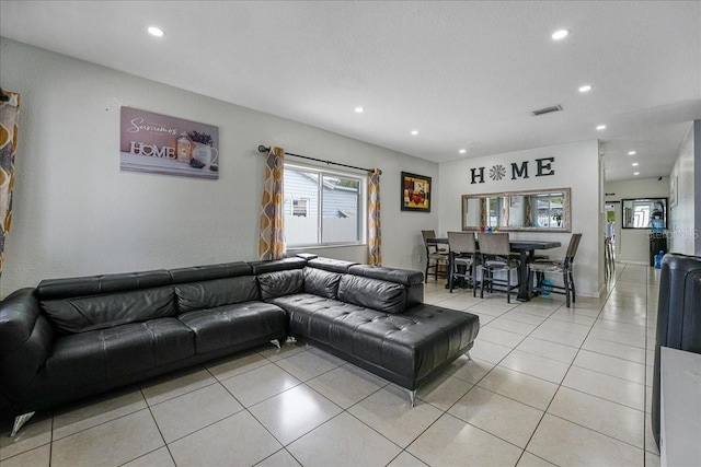 living room featuring light tile patterned floors, recessed lighting, and visible vents