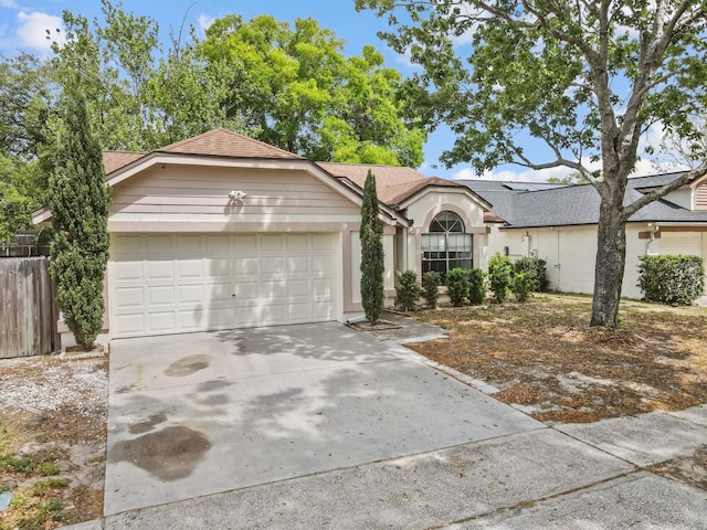 1345 Tindaro Dr, Apopka, FL 32703 - view of front of home with driveway, an attached garage, and roof with shingles