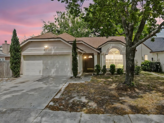 1345 Tindaro Dr, Apopka, FL 32703 - view of front facade featuring concrete driveway, stucco siding, and an attached garage
