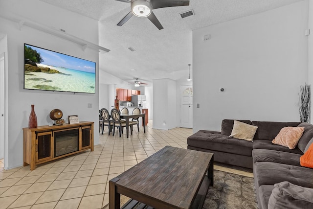 1345 Tindaro Dr, Apopka, FL 32703 - living area featuring lofted ceiling, light tile patterned floors, a textured ceiling, visible vents, and a ceiling fan