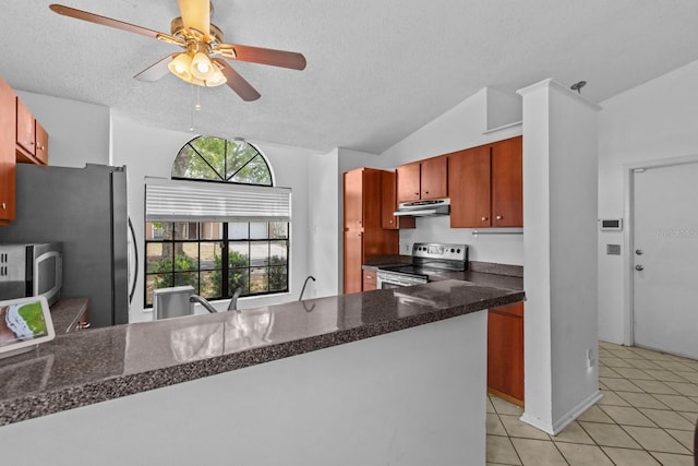 1345 Tindaro Dr, Apopka, FL 32703 - kitchen with light tile patterned floors, under cabinet range hood, dark countertops, a ceiling fan, and appliances with stainless steel finishes