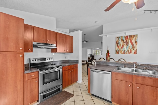 1345 Tindaro Dr, Apopka, FL 32703 - kitchen with light tile patterned flooring, a sink, a ceiling fan, under cabinet range hood, and stainless steel appliances