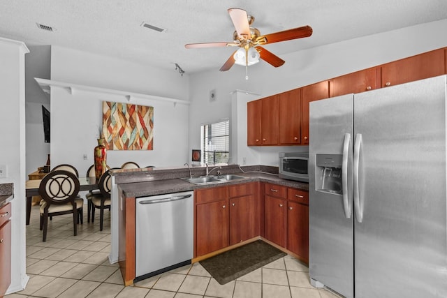 1345 Tindaro Dr, Apopka, FL 32703 - kitchen featuring a sink, dark countertops, appliances with stainless steel finishes, and a peninsula