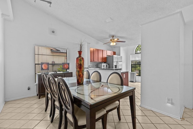 1345 Tindaro Dr, Apopka, FL 32703 - dining space with light tile patterned flooring, a textured ceiling, baseboards, and a ceiling fan