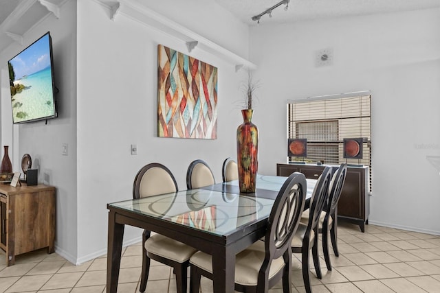 1345 Tindaro Dr, Apopka, FL 32703 - dining area featuring light tile patterned flooring, rail lighting, and baseboards