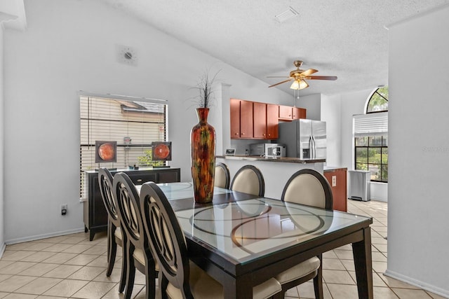 1345 Tindaro Dr, Apopka, FL 32703 - dining area featuring a textured ceiling, lofted ceiling, ceiling fan, and light tile patterned floors