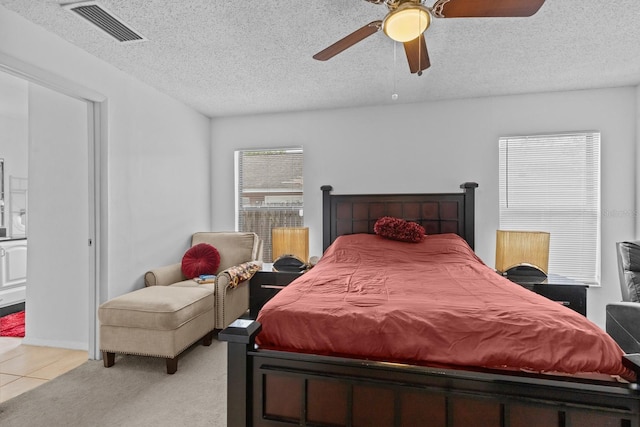 1345 Tindaro Dr, Apopka, FL 32703 - bedroom featuring light colored carpet, visible vents, ceiling fan, and a textured ceiling