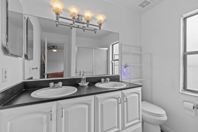 1345 Tindaro Dr, Apopka, FL 32703 - bathroom with a sink, visible vents, toilet, and a shower stall