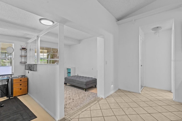 1345 Tindaro Dr, Apopka, FL 32703 - interior space featuring light tile patterned floors, baseboards, vaulted ceiling, and a textured ceiling