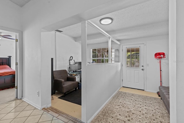 1345 Tindaro Dr, Apopka, FL 32703 - carpeted entrance foyer featuring a ceiling fan, tile patterned floors, baseboards, and a textured ceiling